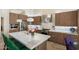 Modern kitchen featuring stainless steel appliances, island with marble countertop and wood cabinets at 7722 E Hartford Dr, Scottsdale, AZ 85255
