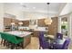 Modern kitchen featuring stainless steel appliances, an island with marble countertop, and stylish pendant lighting at 7722 E Hartford Dr, Scottsdale, AZ 85255