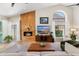 Bright living room featuring vaulted ceilings, a modern fireplace, large windows, and comfortable seating at 7722 E Hartford Dr, Scottsdale, AZ 85255
