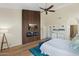 Main bedroom featuring a modern fireplace, a wooden accent wall and stylish decor at 7722 E Hartford Dr, Scottsdale, AZ 85255