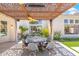 Stylish outdoor patio featuring a dining area and lush landscape at 7722 E Hartford Dr, Scottsdale, AZ 85255