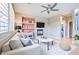 Comfortable living room with a modern ceiling fan, fireplace, and stylish built-in shelves at 1237 E Marcella Ln, Gilbert, AZ 85295