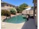 Beautiful backyard swimming pool with rock features and desert landscaping at 17394 W Pima St, Goodyear, AZ 85338