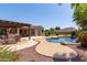 Expansive backyard features a pool with waterfall, outdoor kitchen, covered patio, and manicured landscaping at 19515 E Via Del Palo --, Queen Creek, AZ 85142