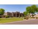 Attractive desert home with manicured lawn, mature trees, and a walkway leading to the inviting front entrance at 19515 E Via Del Palo --, Queen Creek, AZ 85142