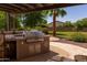 Outdoor kitchen area featuring a built-in grill, counter space, and pergola, perfect for outdoor entertaining at 19515 E Via Del Palo --, Queen Creek, AZ 85142