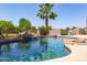 Beautiful pool showcasing sparkling blue water, rock accents, and tropical landscaping creating a serene backyard retreat at 19515 E Via Del Palo --, Queen Creek, AZ 85142