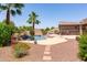 Resort-style pool area with lush landscaping, a charming rock waterfall, and ample space for lounging and entertaining at 19515 E Via Del Palo --, Queen Creek, AZ 85142