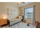 Charming bedroom with colorful decor, a playful rug, and a sun-drenched window at 4010 W Mariposa Grande --, Glendale, AZ 85310