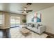 Cozy living room with a modern sofa, ceiling fan, and sliding glass doors to the backyard at 4010 W Mariposa Grande --, Glendale, AZ 85310