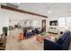 Bright, open-concept living room featuring modern furnishings, wood beam, and hardwood floors at 20815 N 119 Th Ave, Sun City, AZ 85373