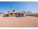 Exterior view of backyard showcasing low-maintenance landscaping, covered patio, and block wall for privacy at 4906 E Evergreen St, Mesa, AZ 85205