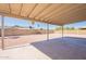Open backyard featuring a large, covered patio, low-maintenance desert landscaping, and block wall fencing at 4906 E Evergreen St, Mesa, AZ 85205