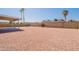 Spacious backyard with low maintenance landscaping, a covered patio, and block wall fencing for privacy at 4906 E Evergreen St, Mesa, AZ 85205