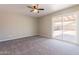A large bedroom has a ceiling fan and sliding glass door to the patio at 4906 E Evergreen St, Mesa, AZ 85205