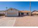 Inviting single-Gathering home features a two-car garage, low maintenance desert landscaping, and neutral color palette at 4906 E Evergreen St, Mesa, AZ 85205