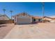 Well-kept home featuring a spacious driveway, desert landscaping, neutral tones, and an attached two car garage at 4906 E Evergreen St, Mesa, AZ 85205
