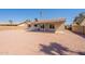 Rear exterior of the home with low maintenance backyard featuring a covered patio, block wall fencing and desert landscaping at 4906 E Evergreen St, Mesa, AZ 85205