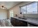 Bright kitchen with granite counters, stainless steel sink, and sliding door access to the backyard at 4906 E Evergreen St, Mesa, AZ 85205