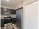 Updated kitchen with stainless steel appliances, granite counters, dark cabinets and plenty of storage space at 4906 E Evergreen St, Mesa, AZ 85205