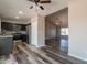 Open floor plan showcasing the kitchen, living room, and dark wood-look flooring throughout the space at 4906 E Evergreen St, Mesa, AZ 85205