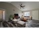A staged living room features modern decor, grey floors, and a ceiling fan at 4906 E Evergreen St, Mesa, AZ 85205