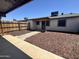 A nice backyard with a wood fence, wood chips, and a patio walkway at 5120 W Willow Ave, Glendale, AZ 85304