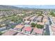 Expansive aerial view of a well-maintained residential community with a pool and mountain views in the distance at 7533 S 31St Pl, Phoenix, AZ 85042