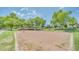 Community sand volleyball court surrounded by green grass and mature trees, great for outdoor recreation at 7533 S 31St Pl, Phoenix, AZ 85042