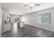 Open-concept living space showcasing kitchen with island, vinyl flooring, and natural light from a window at 10311 N 115Th Ave, Youngtown, AZ 85363