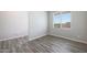 Bright, spacious bedroom with wood-look flooring and natural light, ideal for relaxing and unwinding at 10341 N 115Th Ave, Youngtown, AZ 85363