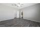 A roomy bedroom is enhanced with a ceiling fan and gray wood flooring at 10341 N 115Th Ave, Youngtown, AZ 85363