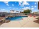 View of the backyard featuring a pebble-tec pool, desert landscaping, and outdoor seating at 10551 W Jessie Ln, Peoria, AZ 85383