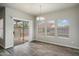 Dining area with sliding door to the patio and three large windows at 10551 W Jessie Ln, Peoria, AZ 85383