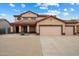 Inviting two-story home featuring a three-car garage and desert landscaping at 10551 W Jessie Ln, Peoria, AZ 85383