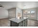 Kitchen island with granite countertop that opens up to the living area at 10551 W Jessie Ln, Peoria, AZ 85383