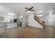 Open-concept living area with wood floors, neutral walls, and staircase at 10551 W Jessie Ln, Peoria, AZ 85383