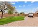 This beautiful backyard features green grass, desert landscaping, and a jacuzzi tub for relaxation at 10603 E Firewheel Dr, Scottsdale, AZ 85255