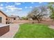 Expansive backyard featuring a lush lawn, mature landscaping, and an inviting hot tub for relaxation at 10603 E Firewheel Dr, Scottsdale, AZ 85255