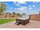 Luxurious backyard showcasing a modern hot tub, brick patio, and serene outdoor retreat at 10603 E Firewheel Dr, Scottsdale, AZ 85255