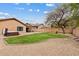 Spacious backyard with a manicured lawn, stone patio, and hot tub, perfect for outdoor entertaining at 10603 E Firewheel Dr, Scottsdale, AZ 85255