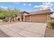 Charming single story home with a three car garage and desert landscaping at 10603 E Firewheel Dr, Scottsdale, AZ 85255