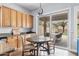 Cozy kitchen nook features oak cabinets, granite counters, and sliding doors to outdoor patio at 10603 E Firewheel Dr, Scottsdale, AZ 85255