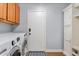 Well-equipped laundry room with washer, dryer, storage cabinets, and convenient access to the backyard at 10603 E Firewheel Dr, Scottsdale, AZ 85255
