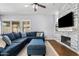 Bright and airy living room has sliding doors to the backyard and a cozy stone fireplace at 10603 E Firewheel Dr, Scottsdale, AZ 85255