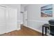 A hallway view with two white doors, a closet, baseboards, and a neutral painted wall with a painting at 10603 E Firewheel Dr, Scottsdale, AZ 85255