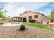 View of the backyard featuring a pool, covered patio, fire pit, and ample space for recreation at 10653 E Lindner Cir, Mesa, AZ 85209