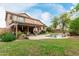 Spacious backyard with pool, patio, and lush landscaping, creating a private outdoor oasis at 10653 E Lindner Cir, Mesa, AZ 85209
