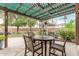 Landscaped backyard with a covered patio and a lush green lawn at 10653 E Lindner Cir, Mesa, AZ 85209