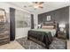 Comfortable bedroom features a large window, a gray accent wall, and stylish decor at 10653 E Lindner Cir, Mesa, AZ 85209